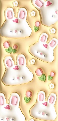 a cookie sheet with bunny ears and flowers on it's side, in the shape of rabbits