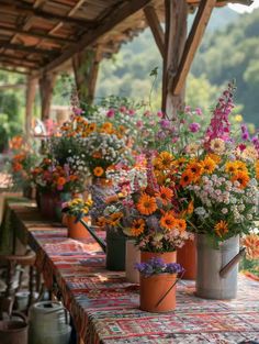 many flowers are in buckets on the table