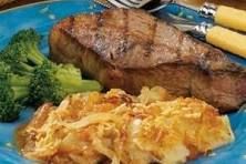 a blue plate topped with steak and broccoli