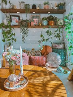 a wooden table topped with lots of different types of plants and vases on top of it