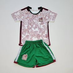 a white and green soccer uniform with red trim on the chest, two matching shorts