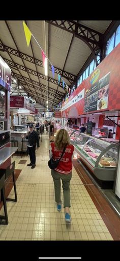 a woman is walking through the food court