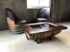 two chairs sitting next to each other in front of a table with a glass top