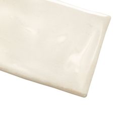 a white ceramic square dish on a white background