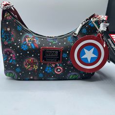 Loungefly Marvel Avengers Tattoo Crossbody Purse Show Off Your Marvel Fandom With This Avengers Tattoo Purse! It Is Made Of Faux Leather And Features A Top Zipper Closure , Adjustable Strap, Coin Bag, Matching Themed Lining, And Printed Details. This Purse Approximately Measures 8 3/4-Inches Wide X 6-Inches Tall X 2 1/2-Inches Deep. Ages 8 And Up Marvel Fandom, Coin Bag, Crossbody Purse, Marvel Avengers, Purses Crossbody, 6 Inches