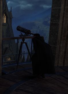 a man looking through a telescope at a castle