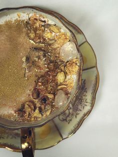 a plate filled with food on top of a white tablecloth covered table next to a silver spoon