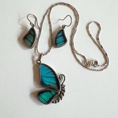 These amazing set of butterfly earrings and necklace are very special as they are made from real butterfly wings!  They are reversible so you can see the colour on one side and browns on the underside. Very unique set for the butterfly lover!  Price is for the set of earrings and necklace. Size: Pendant - 18" chain, pendant 1.5" drop, Earrings 1 1/2" drop Condition - Excellent MARKING: 950 (which has a higher silver content than 925) To see my other jewelry, click here: https://etsy.me/3A8crke T Elegant Turquoise Butterfly Jewelry, Blue Butterfly Sterling Silver Jewelry, Silver Butterfly Jewelry With Matching Earrings, Unique Sterling Silver Jewelry With Butterfly Charm, Turquoise Butterfly Sterling Silver Jewelry, Unique Butterfly-shaped Jewelry With Matching Earrings, Blue Wing-shaped Jewelry Gift, Turquoise Butterfly Jewelry For Gifts, Turquoise Butterfly Jewelry For Gift