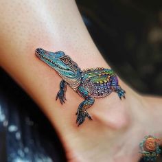 a colorful lizard tattoo on the foot