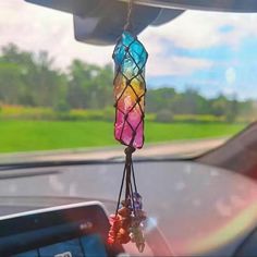 a car dashboard with a wind chime hanging from it's side