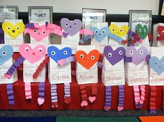 some paper bags with hearts and faces on them are sitting in front of other items