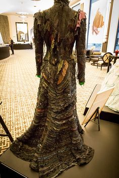 a dress made out of clothes on display in a room