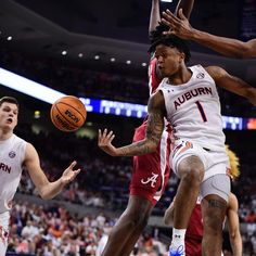 the basketball players are trying to block the ball from being fouled by another player