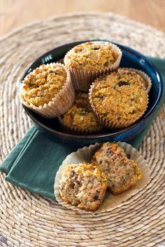 some muffins are sitting on a wicker place mat