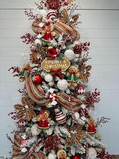 a christmas tree decorated with red, white and gold ornaments