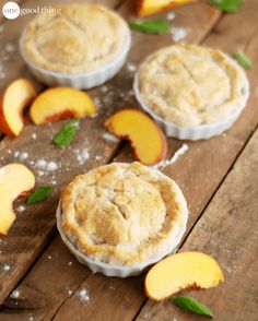 small pies with fresh peaches on a wooden table