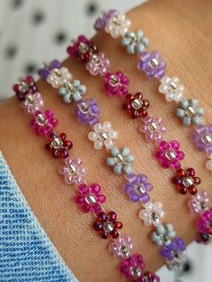 a woman's arm with several bracelets made out of beads and glass beads