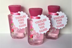 three pink bottles with labels on them that say, tickled pink you can smell