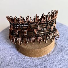 You'll love this wide, chunky, one-of-a-kind artisanal copper wire cuff. Handcrafted with copper wire, this cuff features intricate details and an adjustable fit. Oxidized and hand polished, this cuff has been coated to preserve the finish. I love the fringe effect on the wrapping on the top and bottom. One size fits most - adjust by gently pulling and squeezing the sides Copper wire Handmade in Lincoln, Nebraska Unique Copper Wire Wrapped Cuff Bracelet, Bohemian Copper Wire Wrapped Cuff Bracelet, Handmade Bohemian Copper Wire Cuff Bracelet, Unique Copper Wire Cuff Bracelet Gift, Adjustable Wire Wrapped Bronze Cuff Bracelet, Artisan Adjustable Wire Wrapped Cuff Bracelet, Handmade Copper Wire Cuff Bangle, Handmade Copper Wire Cuff Bracelet Bangle, Artisan Copper Cuff Bangle Bracelet