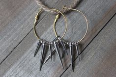 These gold hoop earrings have 4 silver spikes hanging from them with round silver beads in between. Two of the spikes are .75" long and the other two are 1.25" long. Jewelry Earrings Hoops, Gold Hoop, Gold Hoop Earrings, Silver Beads, Favorite Jewelry, Handmade Items, Hoop Earrings, Jewelry Earrings, Accessory Gift