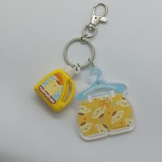 a plastic key chain with a cartoon character on it and a rubber clip attached to it