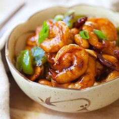 a bowl filled with shrimp and peppers on top of a table