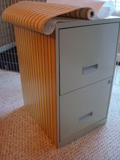 a filing cabinet sitting on top of a carpeted floor