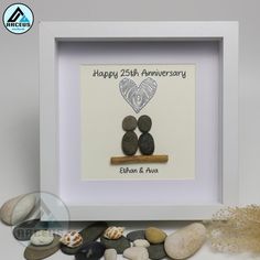 an anniversary card with two rocks in the shape of a heart