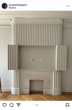 an empty room with a fireplace and white walls