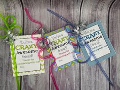 two tags that say you're a crazy awesome person and have ribbons attached to them