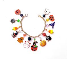 This happy and colorful Halloween charm bracelet is handcrafted by myself, and contains an assortment of enamel charms.  The gold plated chain is 7 3/4 inches long with 13 charms containing  jack o lanterns, ghosts, a cat and web.  If you need it shorter or longer just let me know, and I will adjust it to as close as possible to the size you desire. If you would like a charm switched to something else just ask!  Each charm is placed with thought  for color and balance.  It is  a really fun piece Novelty Multicolor Charm Bracelet, Halloween Novelty Jewelry With Charms, Handmade Halloween Charm Bracelet Gift, Handmade Charm Bracelet For Halloween Gift, Fun Multicolor Halloween Jewelry, Halloween Charm Bracelet, Colorful Halloween, Cat Candle, Jack O Lanterns