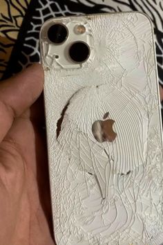 someone is holding an iphone case that has been cracked