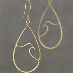 a pair of gold - plated earrings with swirly lines and tear shaped drops