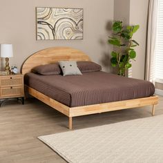 a bed sitting on top of a wooden floor next to a dresser and lamp in a bedroom