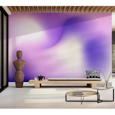 a living room filled with furniture and a purple wall