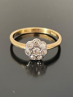 A very pretty little antique daisy cluster ring set with small old cut diamonds, the stones are set in platinum an 18ct yellow gold shank. The cluster measures 7.16mm in diameter Stamped 18CT. size is (UK) - K/ US 5.5/ French 52 Weight 2.4 grams Triple Daisy Cluster Diamond Ring, Cluster Ring Set, Flower Ring, Cluster Ring, Daisy Flower, Rings Statement, Ring Set, Statement Rings, Diamond Cuts