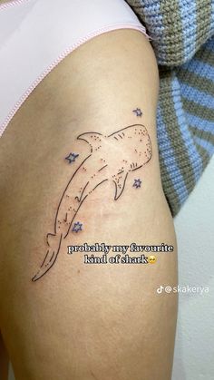 a woman's thigh with a dolphin tattoo on her leg and the words, probably my favorite island of shark