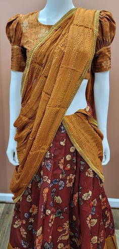 Eloquent Kalamkari Printed Banaras Half Saree set in Brown Blouse size : 32 Inches Lehenga length: 39 inches Anarkali Sets With Zari Work In Traditional Drape, Navratri Raw Silk Sets With Zari Work, Anarkali Tussar Silk Set With Traditional Drape, Anarkali Tussar Silk Set, Brocade Pre-draped Saree With Traditional Patterns, Bollywood Style Tussar Silk Set For Festive Occasions, Festive Silk Set With Unstitched Blouse, Festive Bollywood Style Tussar Silk Sets, Raw Silk Cutdana Unstitched Sets