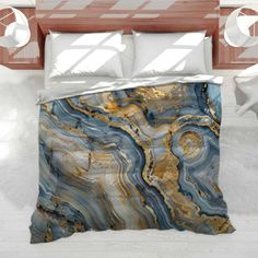 a bed with a blue and gold marble pattern on it