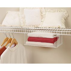 white shelving shelf with folded towels and t - shirts