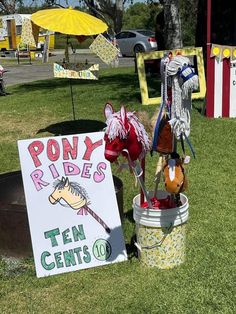 there is a sign that says pony rides and ten cents on the bucket in front of it