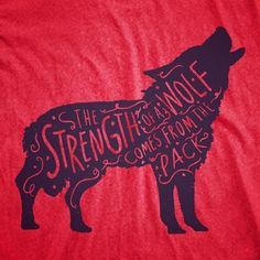 a red t - shirt with a black silhouette of a wolf