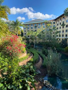 the resort is surrounded by tropical trees and flowers, along with a river running through it