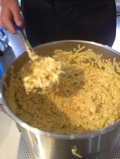 a person is stirring some food in a pot