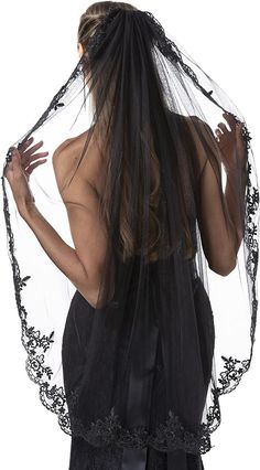 a woman wearing a veil with black lace on the top and bottom, standing in front of a white background