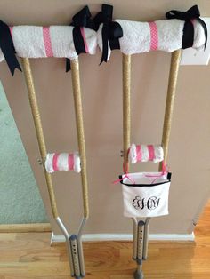 two baby cribs with bows and diapers attached to them, one is pink and the other is white