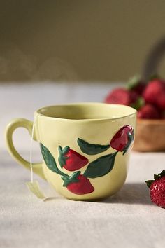 Fresh from the garden, the Foster Mug is crafted from handpainted glazed stoneware, beautifully adorned with embossed produce and blooms. | Foster Stoneware Mug by Anthropologie in Red, Size: MUG/CUP Thrifted Cups, Thrifted Mugs, Spring Mugs, Cute Ceramic Mugs, Things To Thrift, Anthropologie Mugs, Cottagecore Mug, Olive Oil Cruet, Creative Ceramics