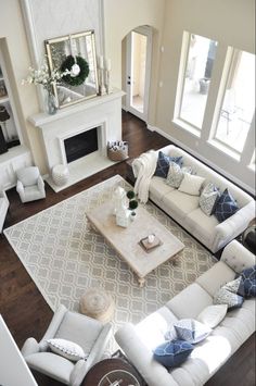 a living room filled with furniture and a fire place in the middle of the room