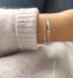 Dainty custom made bracelet with two strands. Perfect piece for everyday wear. Personalize the bar with your favorite name, initial, coordinates, Roman numerals, date or a small symbol.   * Silver bar: 25x4mm / Gold & Rose bar: 30x4mm * Chain:  Cable chain & Satellite chain  * Material: 925 Sterling silver, 14K Gold filled, 14K Rose gold filled    ENGRAVING ----------------- * Max. 16 characters including gaps and punctuation * Both sides of the bar can be engraved  * Engraving: Roman numerals * Sterling Silver Satellite Chain Bracelet For Everyday, Everyday Sterling Silver Chain Bracelet With Satellite Chain, Everyday Sterling Silver Satellite Chain Bracelet, Adjustable Sterling Silver Bracelets For Layering, Sterling Silver Bracelets With Satellite Chain, Silver Sterling Bracelets With Satellite Chain, Silver Sterling Satellite Chain Bracelets, Silver Stackable Name Bracelet For Everyday, Minimalist Sterling Silver Name Bracelet With Jubilee Design