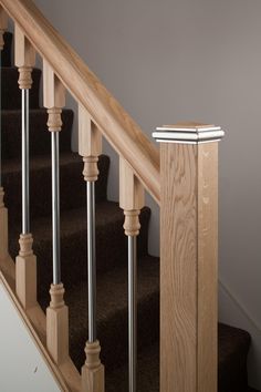 an image of a stair case on the stairs in a house or apartment building with carpeted floors and wood handrails